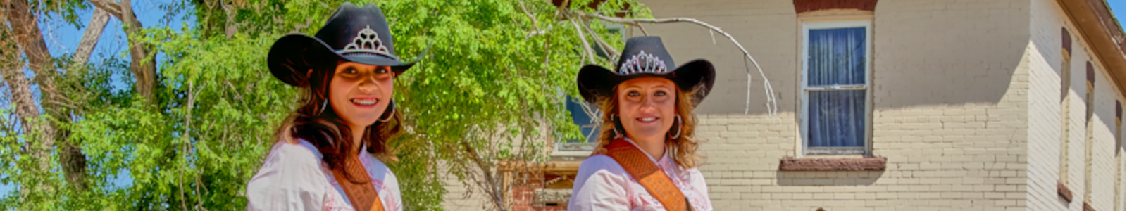 Two cowgirls pose on their horses while at the Grover Colorado Rodeo